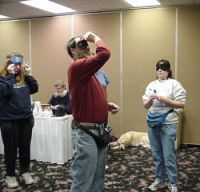 Don throwing, Lisa masking up, and Barb O watching, 2004 tournament