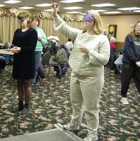 Mary Ellen throwing, Sam and Lisa passing by, 2004 tournament